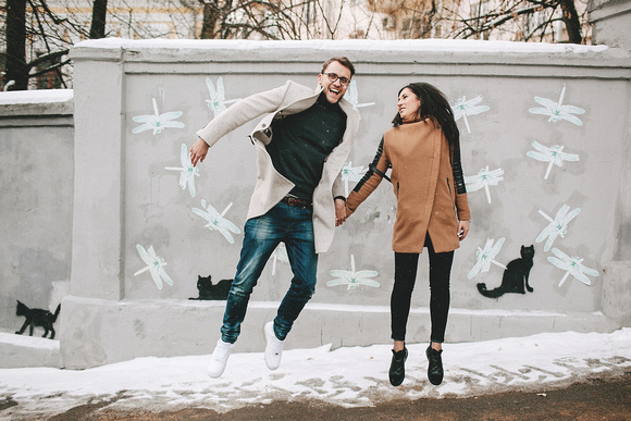 Young couple having fun on the city street in winter