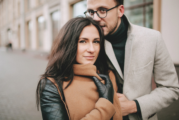 Young couple hugging on the city street in winter