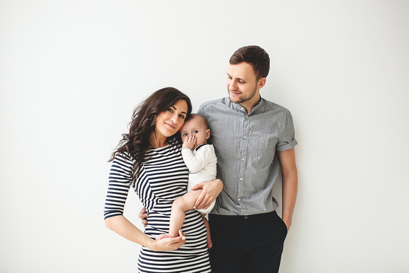 Happy young father mother and baby boy over white background